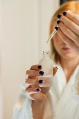 Woman using a dropper to apply serum