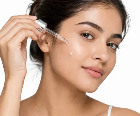 women applying serum on face